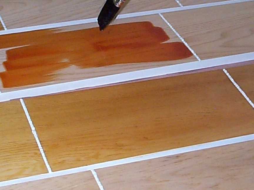 several pieces of wood with coatings being applied.  Some pieces have coatings and some are still to be coated